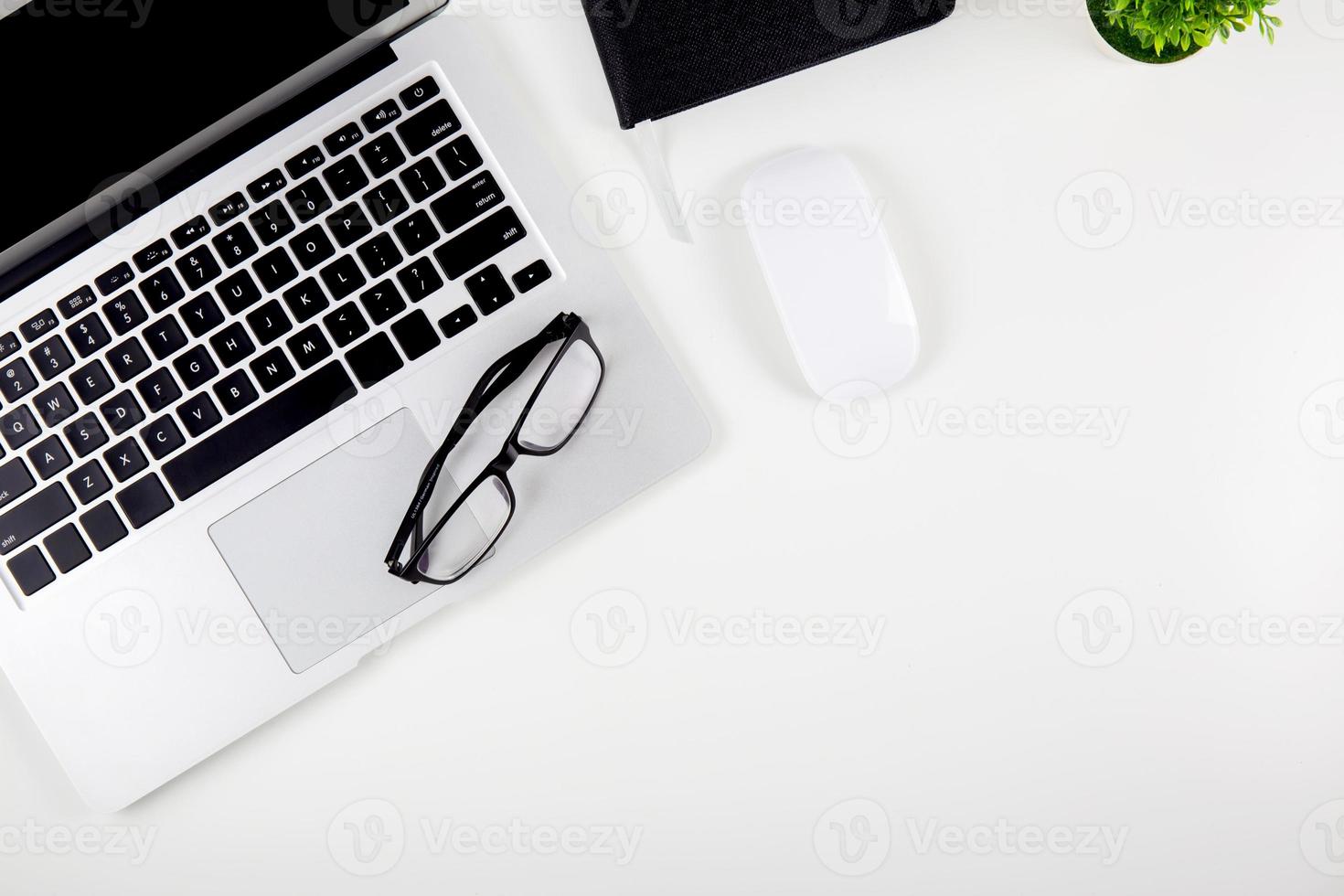 Top view laptop with open display screen monitor, mouse and notepad and glasses isolated on white background, notebook or netbook with keyboard work on desk office, communication technology concept. photo