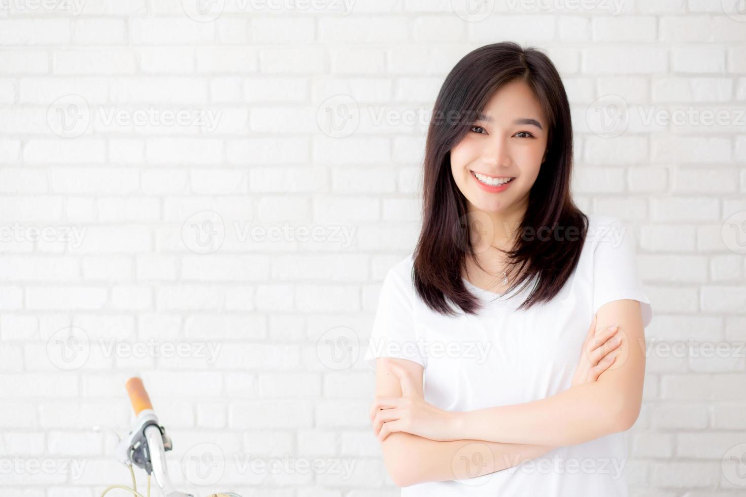 retrato de la hermosa joven mujer asiática felicidad de pie sobre fondo de ladrillo de pared de grunge de textura de cemento gris, mujer de negocios es una sonrisa en concreto, concepto de gente de negocios. foto