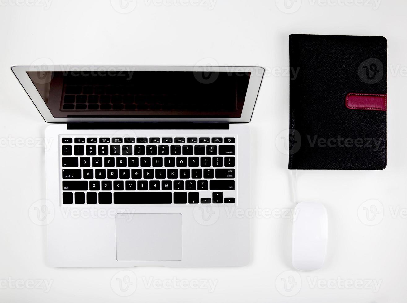 Top view of laptop computer with open display screen monitor, mouse and book isolated on white background, notebook or netbook with keyboard, communication technology concept. photo