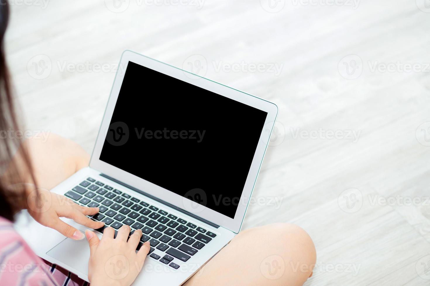 Portrait of beautiful asian young woman setting using laptop computer at on living room for leisure and relax, freelance with girl working notebook, communication and lifestyle concept. photo