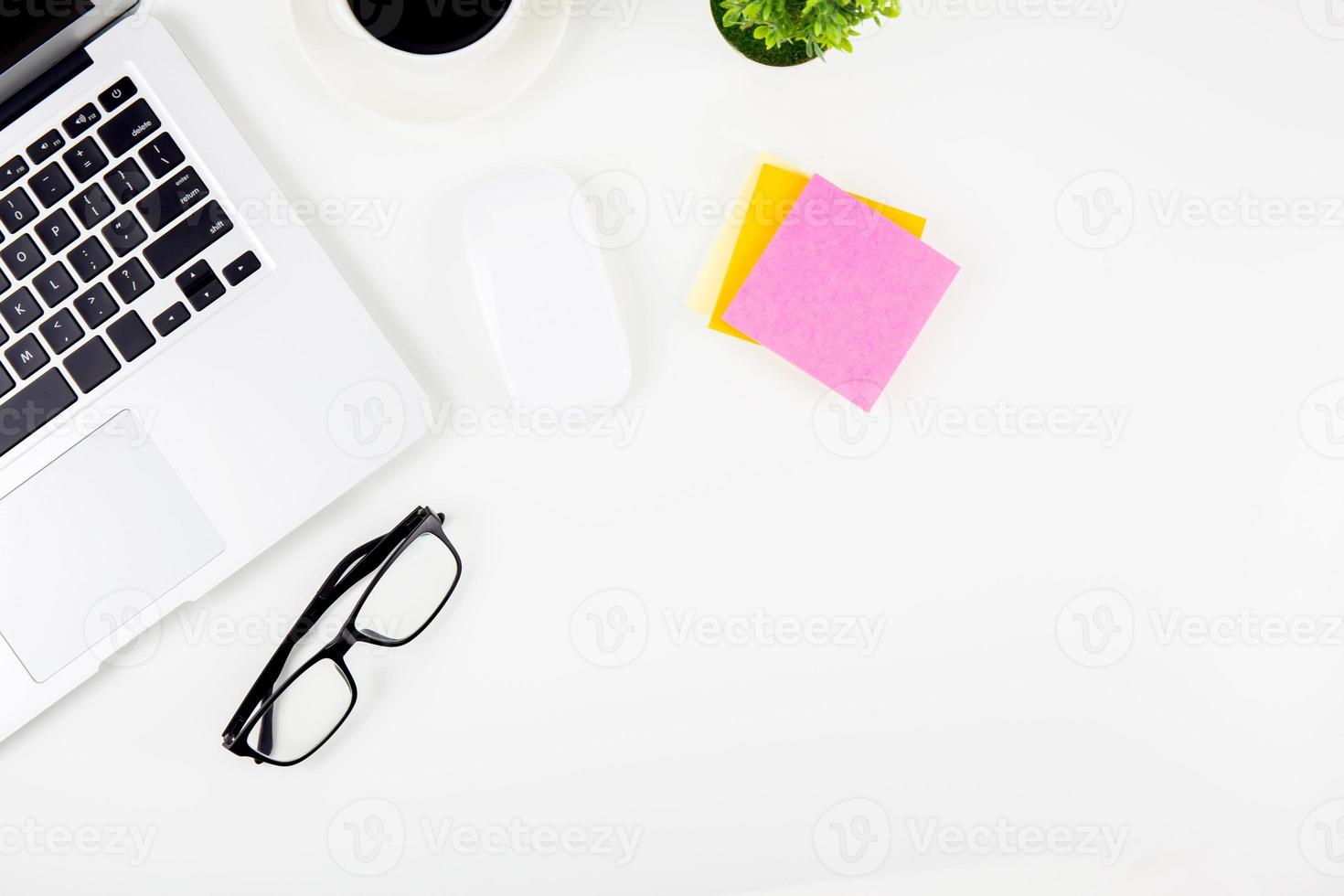 Top view laptop with open display screen monitor, diary and mouse and notepad and glasses isolated on white background, notebook or netbook with keyboard, communication technology on work office. photo