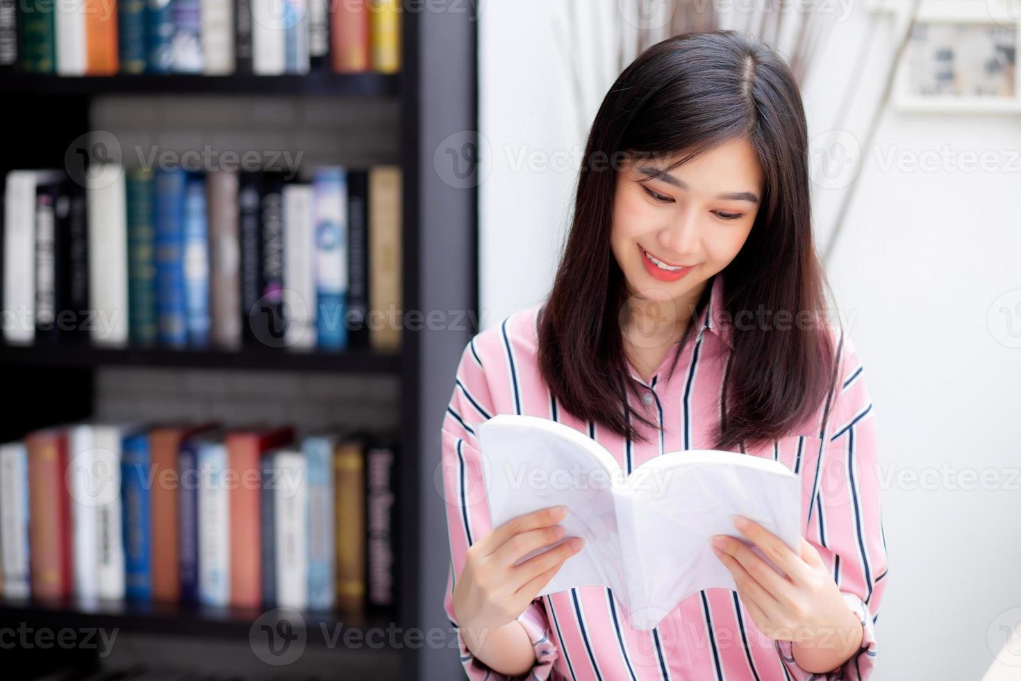 Beautiful of portrait young asian woman relax sitting reading book in living room at home, girl study literature, education and llifestyle concept. photo