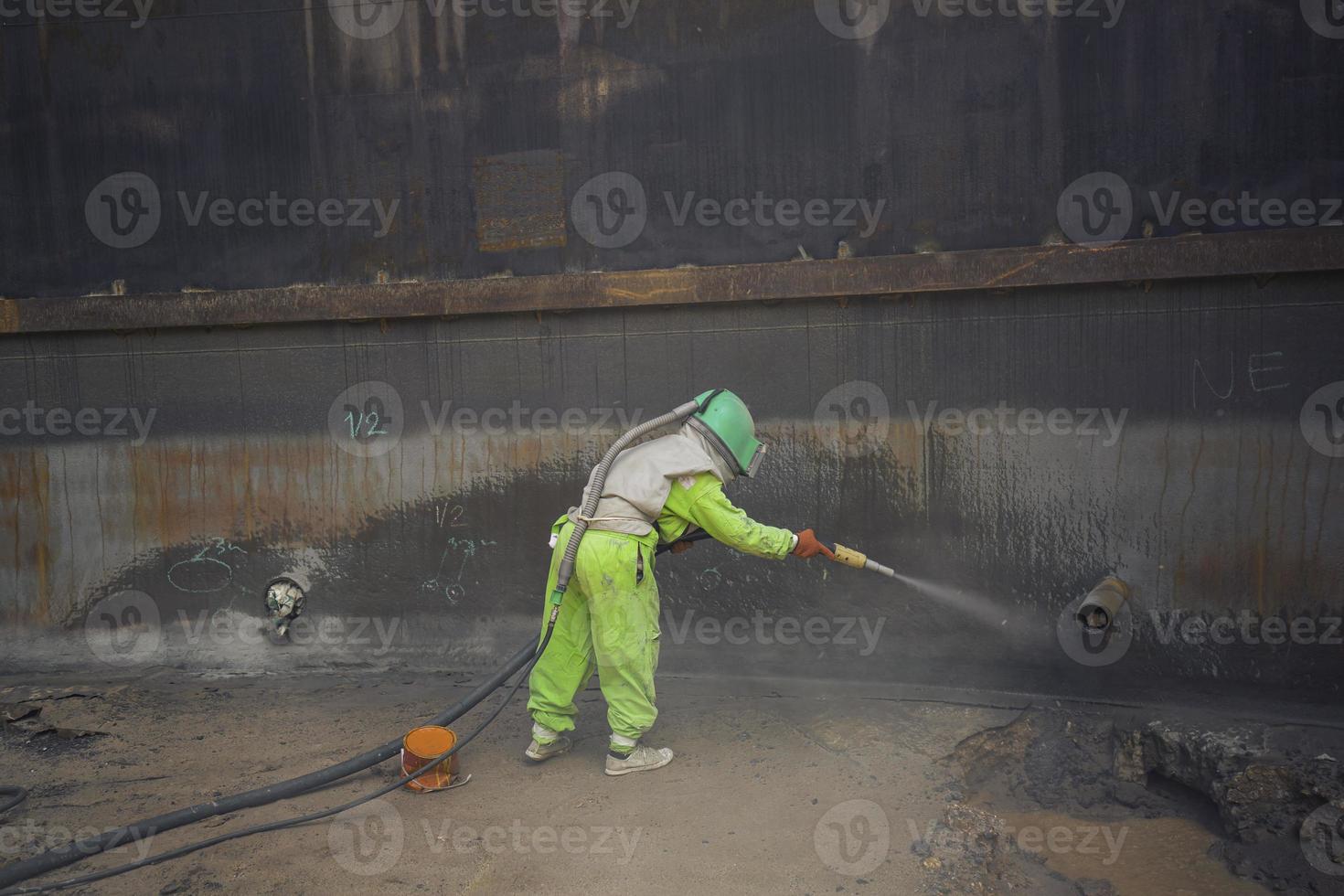 Female worker surface corrosion plate preparation by sand blasting photo