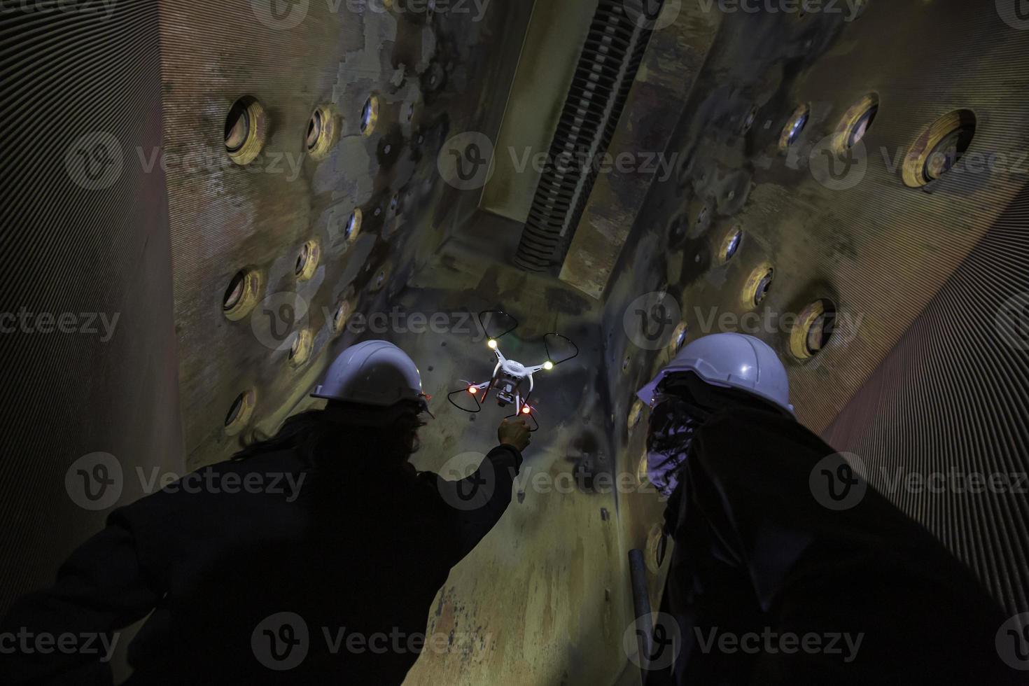 Drone male inspection operated by construction worker on furnace photo