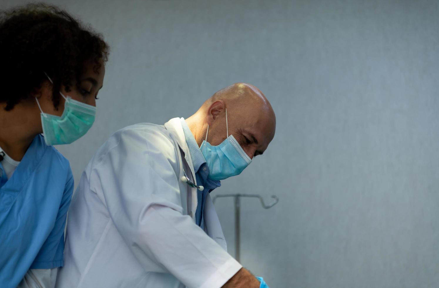 A medical professor is teaching surgery to medical students working photo