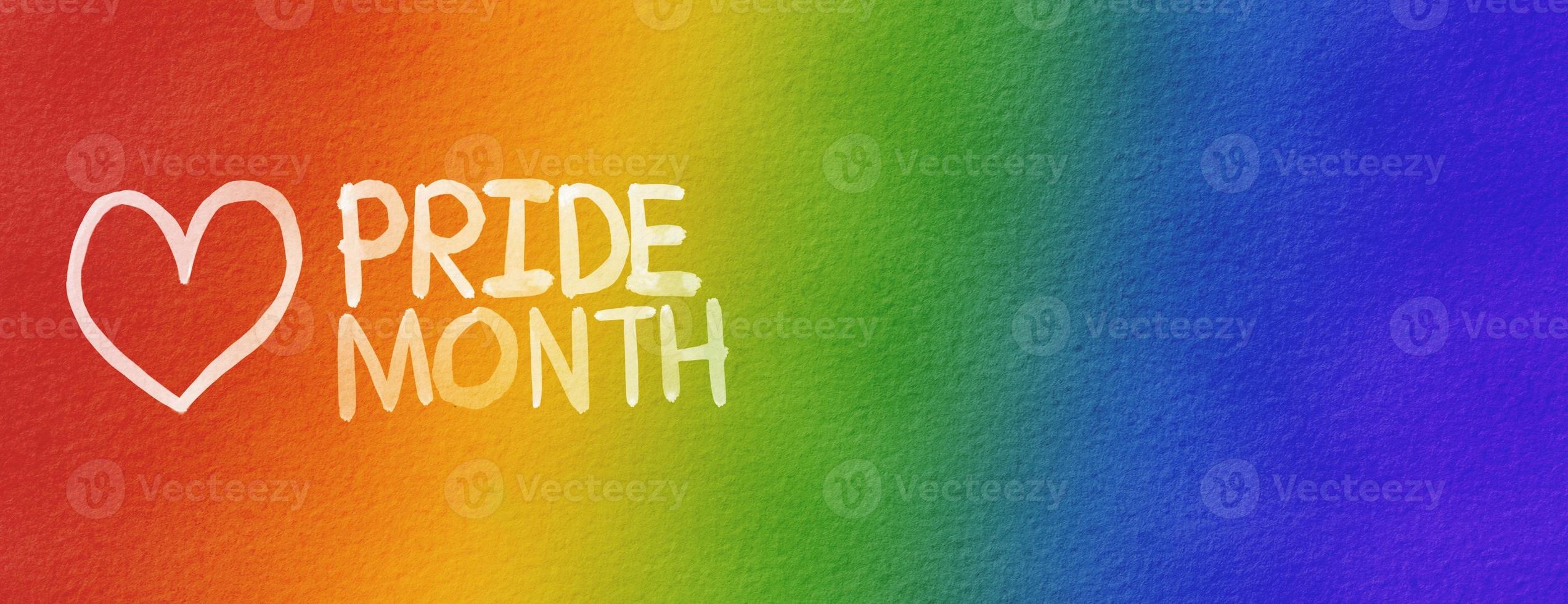 LGBT  Pride month watercolor texture concept. Rainbow background with heart  shape and pride month text. photo
