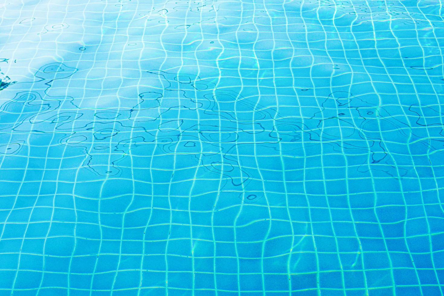 Blue swimming pool with wavy surface. photo