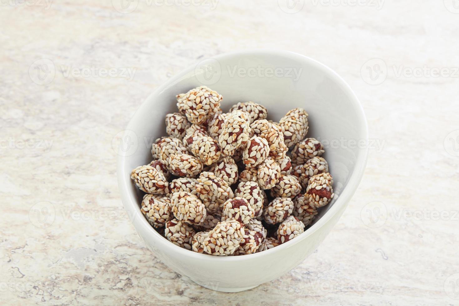 Sweet peanut in sesame seeds photo