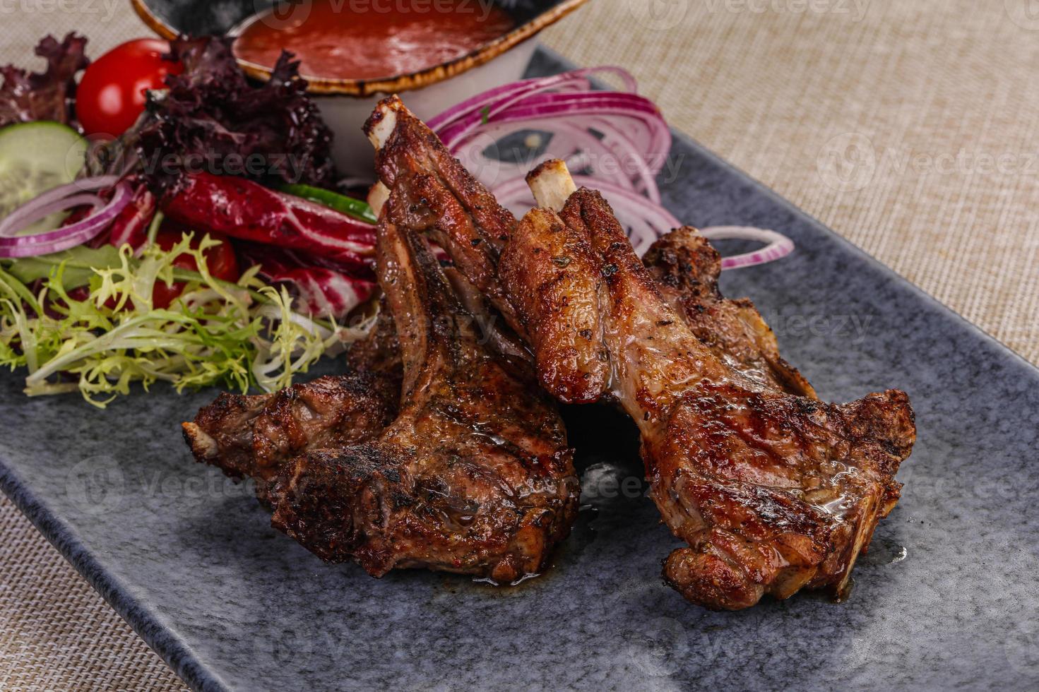 Grilled lamb chops with sauce photo