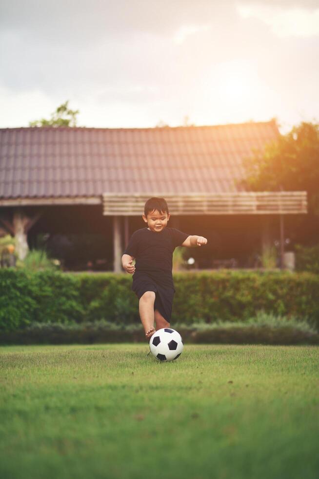 Little Boy playing soccer football photo