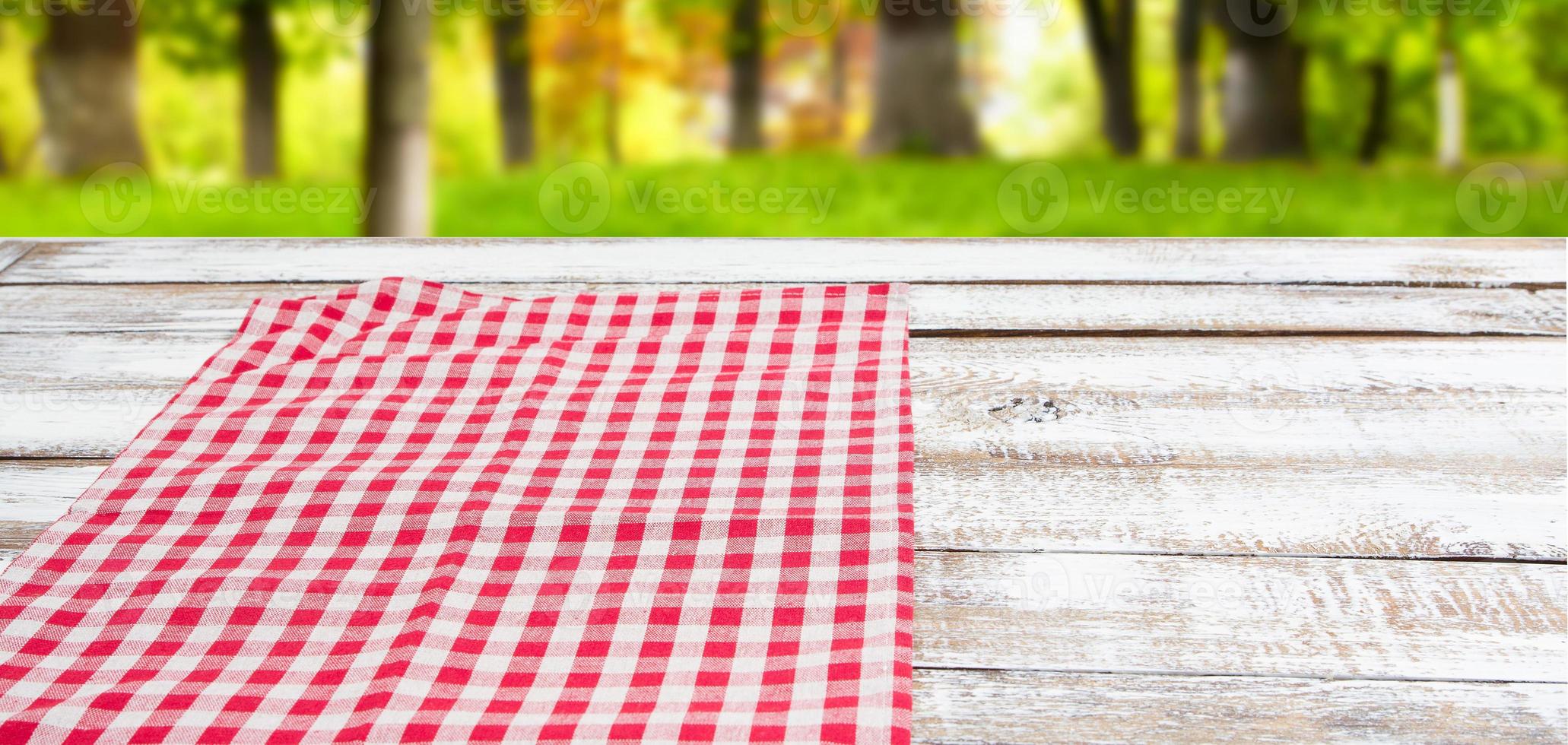 checkered red tablecloth on an empty table - top view photo