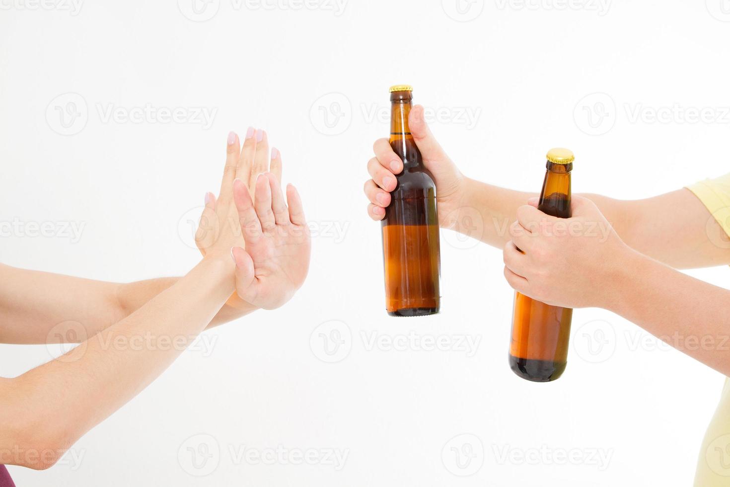 female hand reject a bottle of beer isolated on white background.anti alcohol concept. Copy space photo