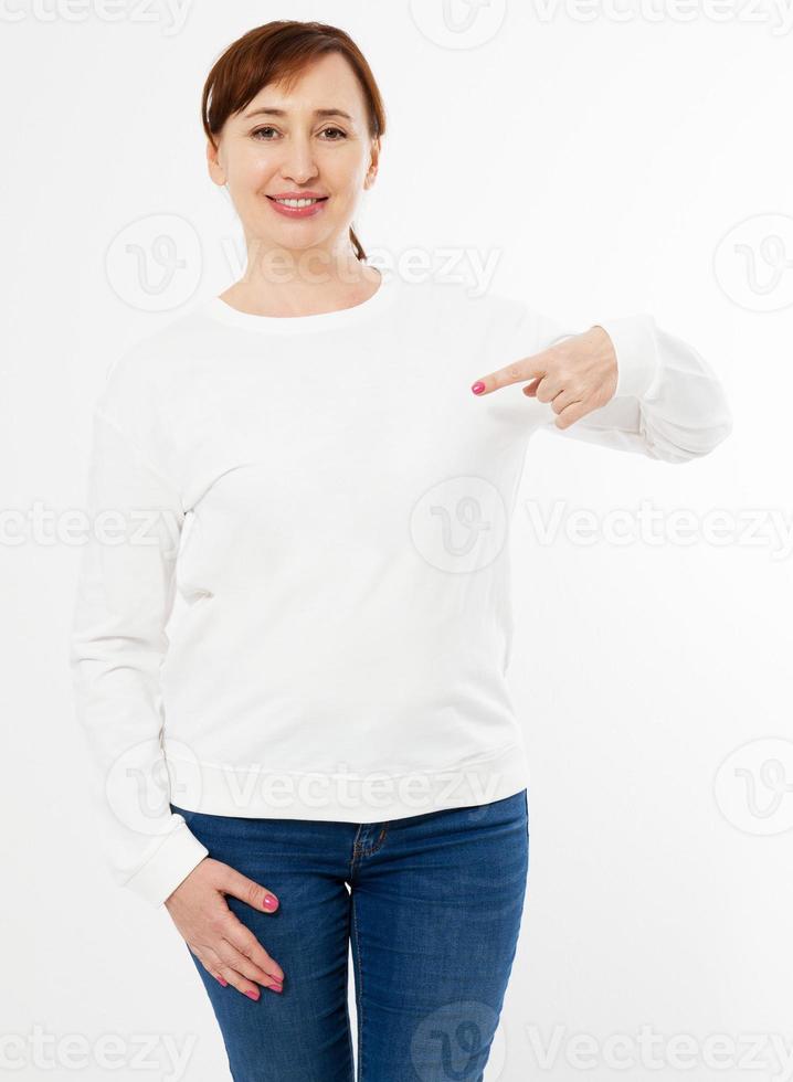 White long sleeve t-shirt on a middle aged woman in jeans and pointed hand isolated, front , mockup photo