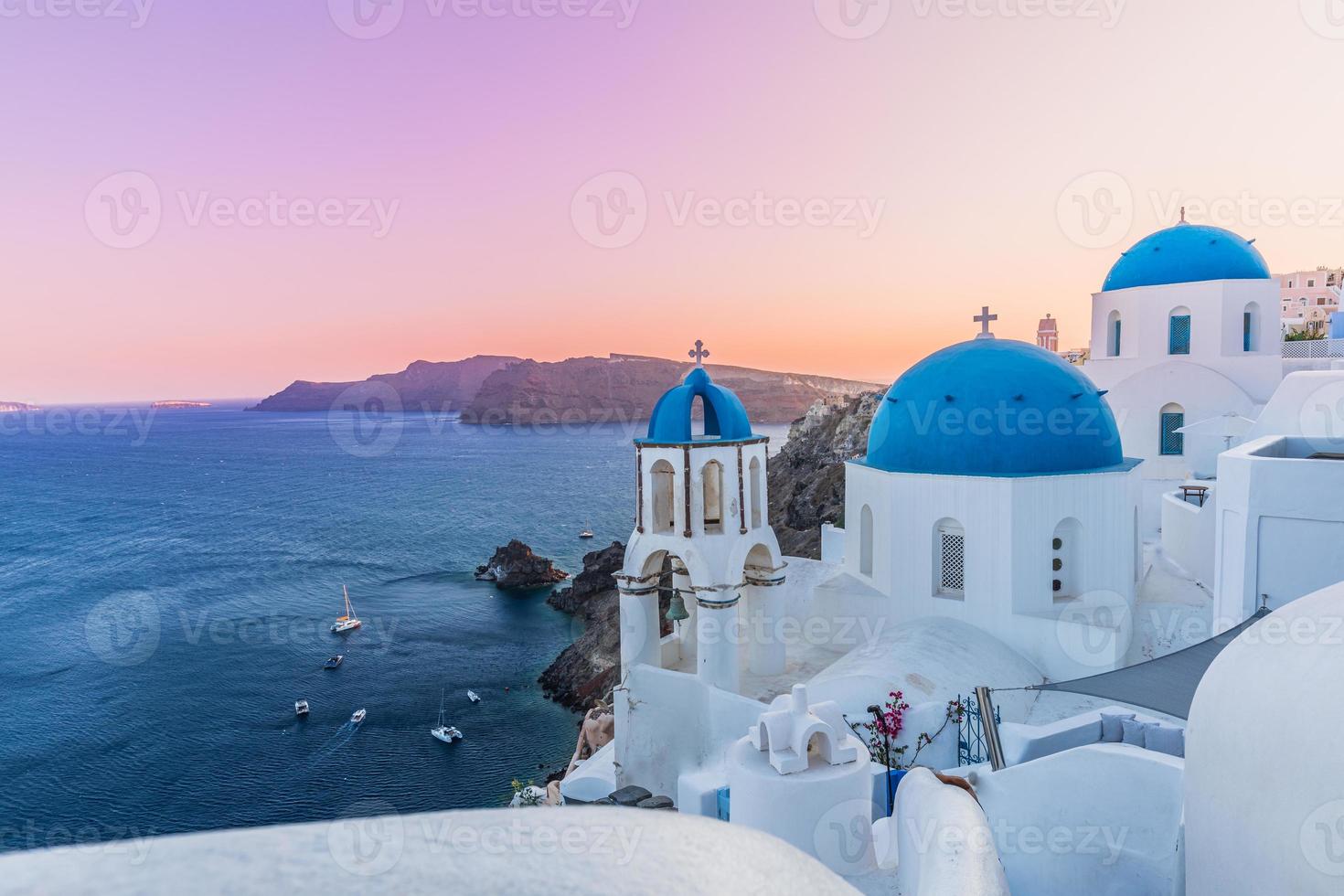 Waiting for the sunset in the village of Oia in the Santorini, Greece. Santorini is an ancient volcano located in the middle of the mediterranean sea, surrounded by crystalline and refreshing waters. photo