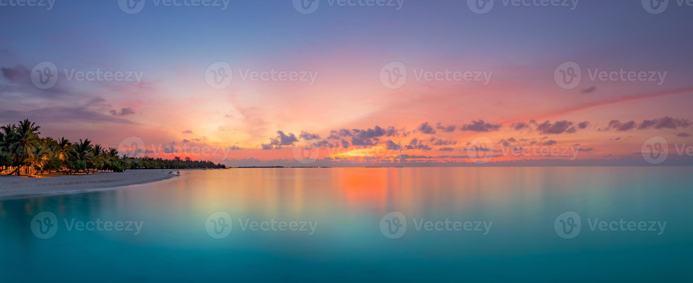 Beautiful panoramic sunset tropical paradise beach. Tranquil summer vacation or holiday landscape. Tropical sunset beach seaside palm calm sea panorama exotic nature view inspirational seascape scenic photo
