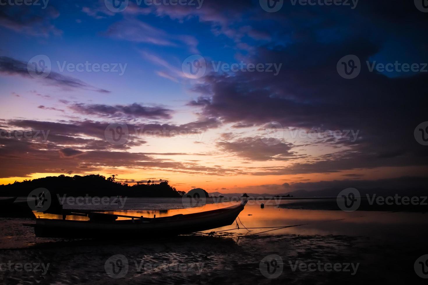 Beautiful Sky and sunset on the beach with Fishing boat silhouette. photo