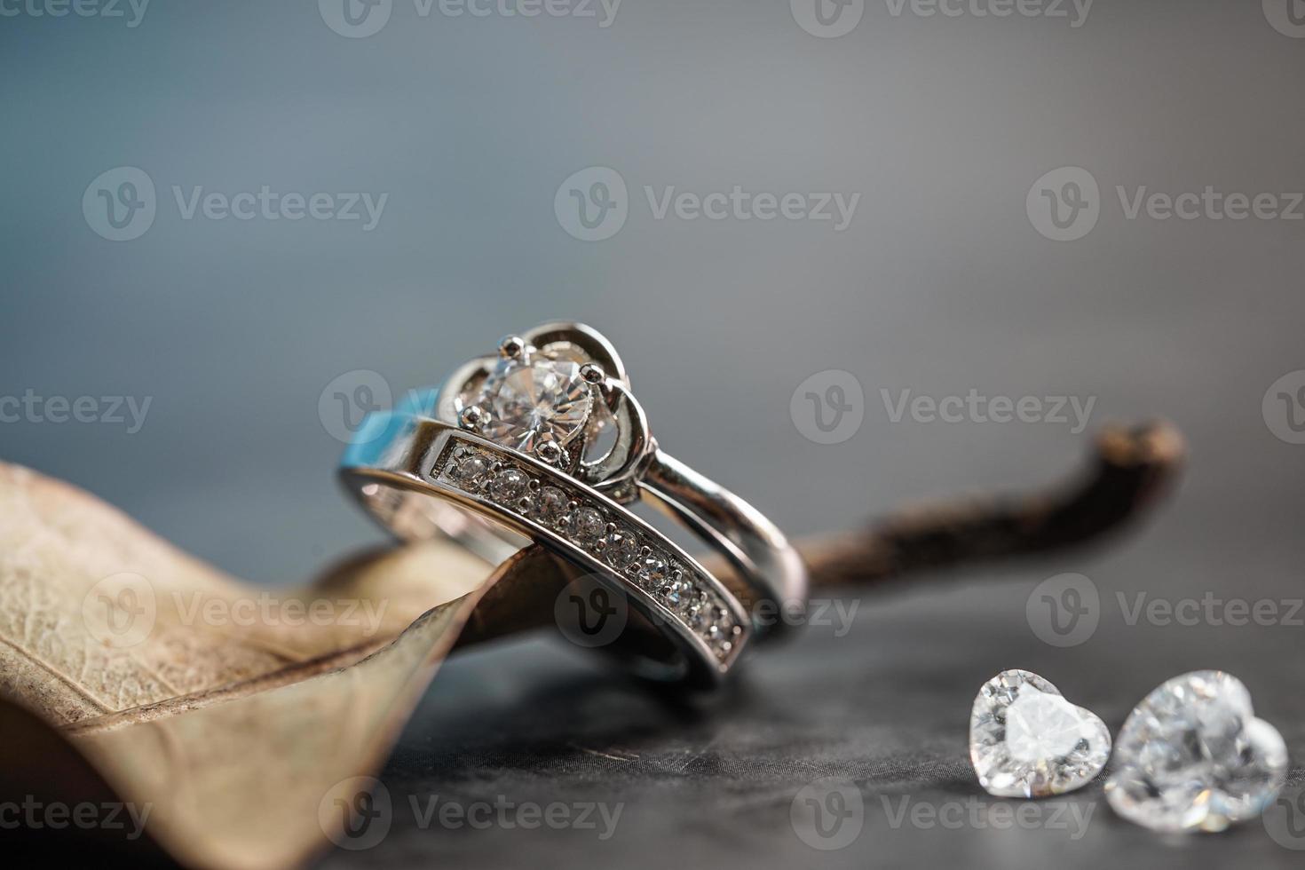 Closeup of a diamond engagement ring placed on a leaf. Love and wedding concept. photo