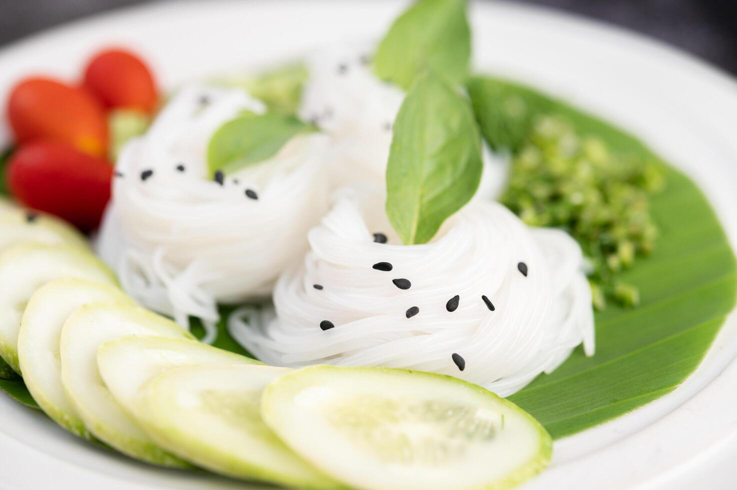 noodles with beautifully laid vegetables and side dishes. Thai food. photo