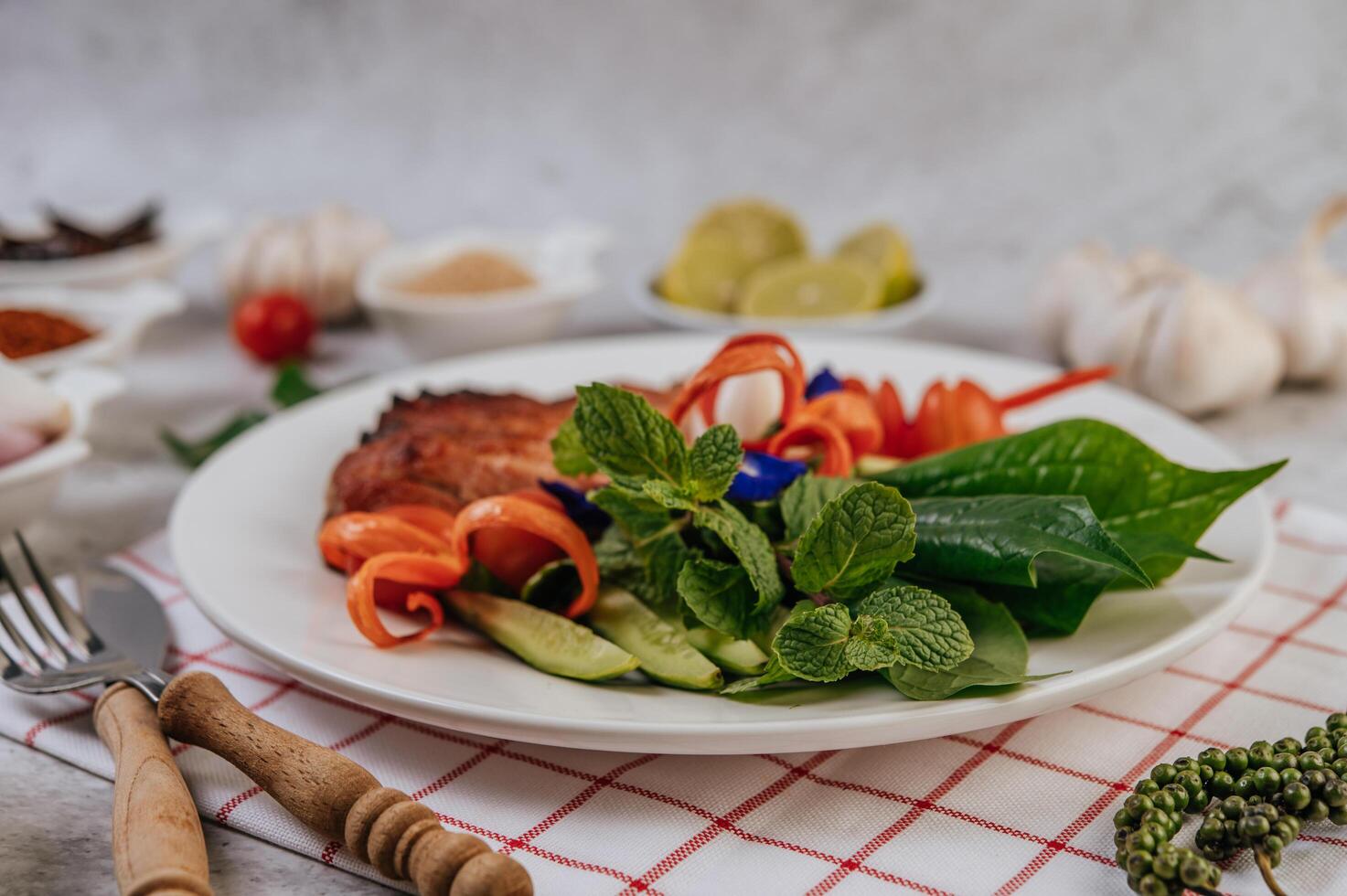 Pork with lemon, onion, red onion, tomato, long bean, butterfly pea flower, and mint. photo