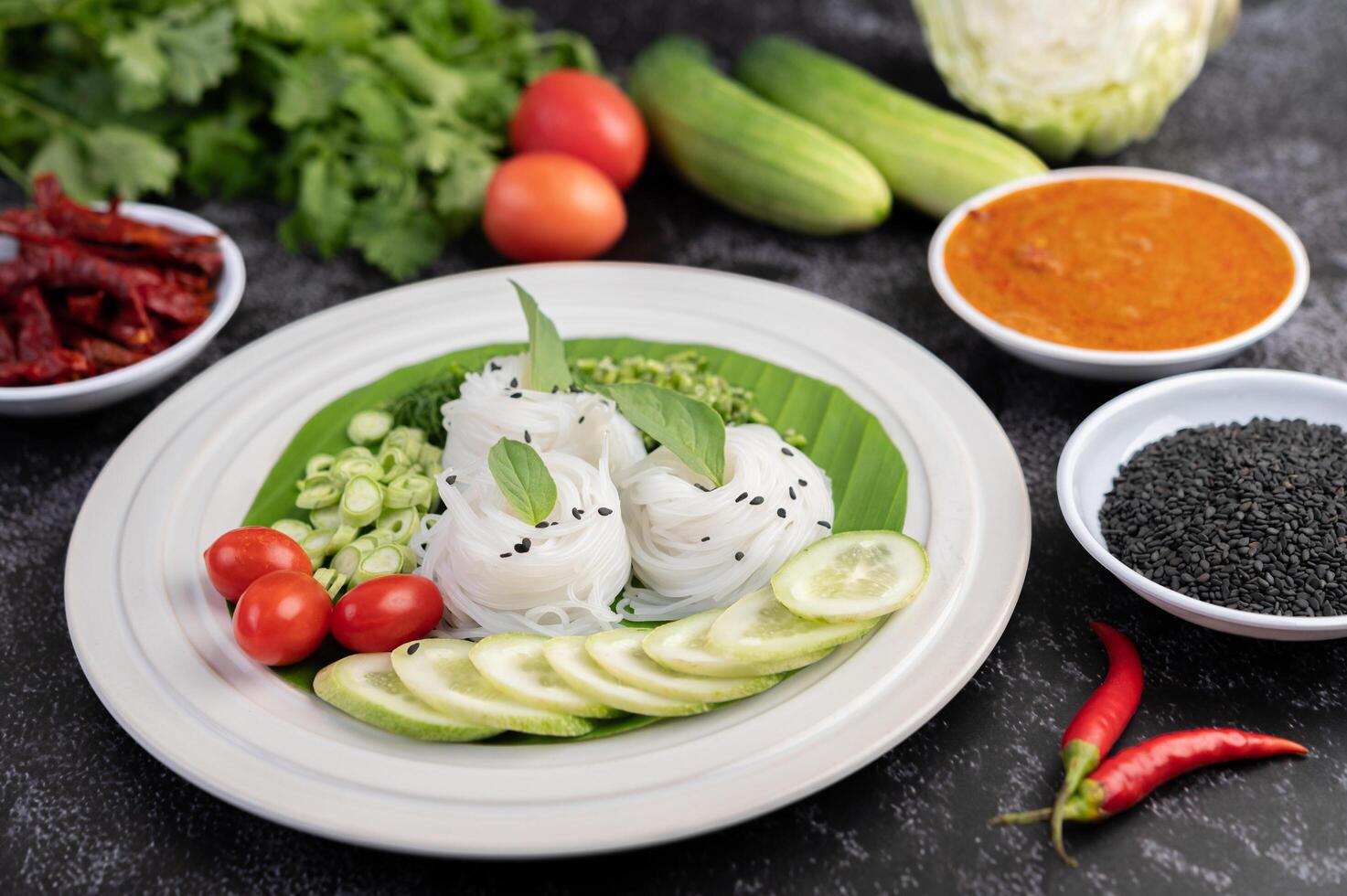 Noodles in a banana leaf with beautifully laid vegetables and side dishes. Thai food. photo