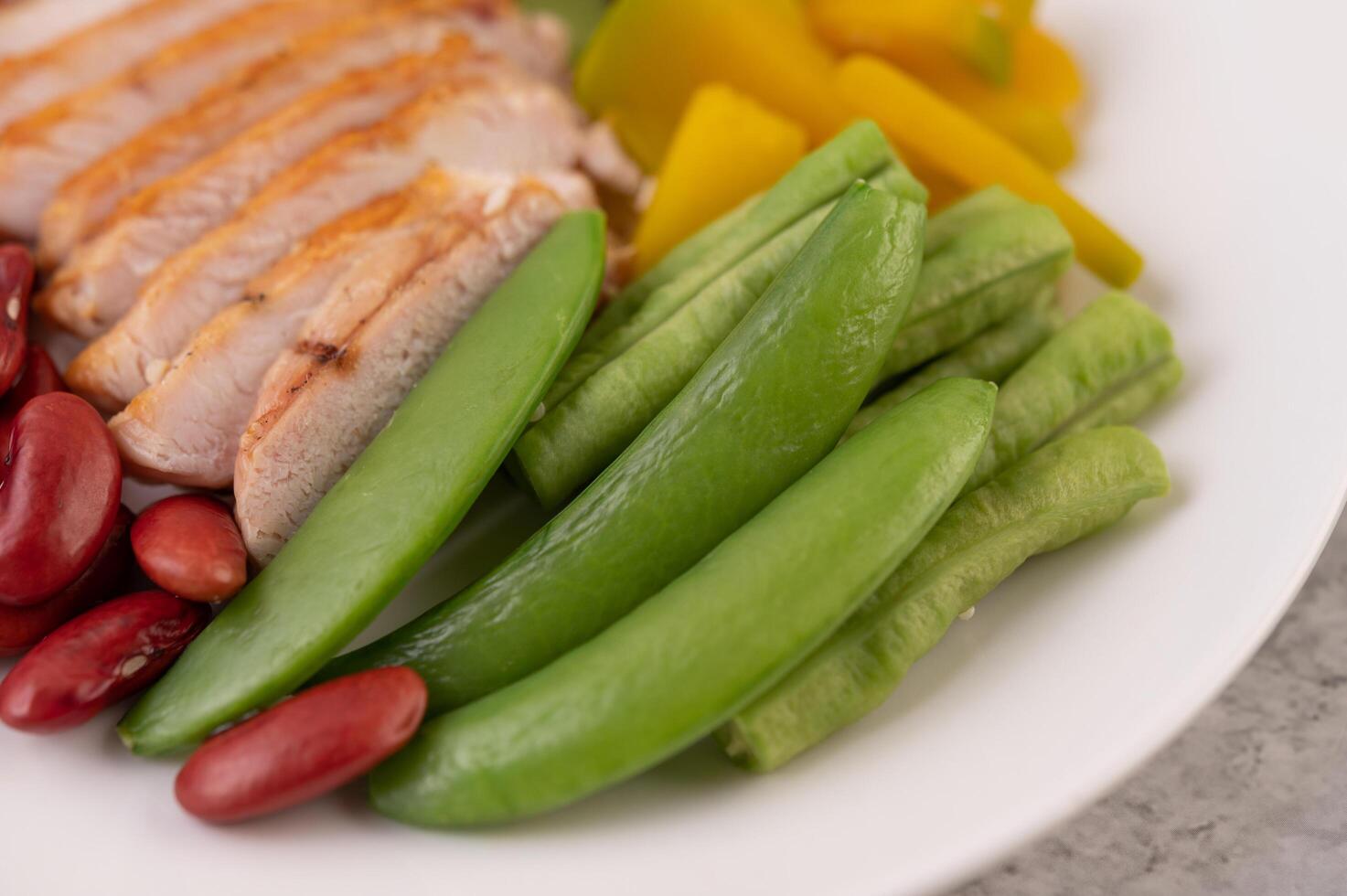 Chicken steak with peas, kiwi and pumpkin. photo