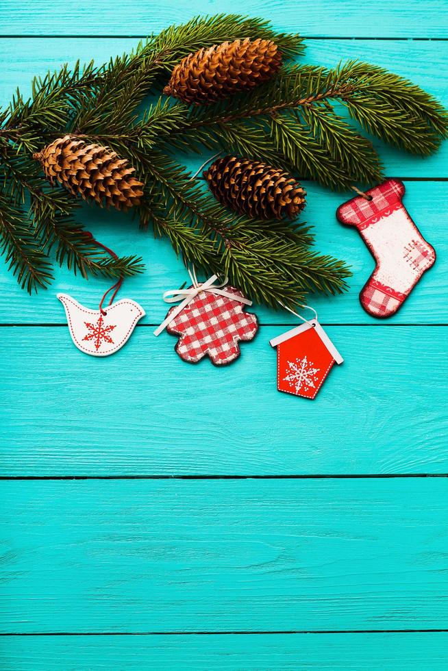 Christmas tree with accessories on blue wooden background with copy space. Top view photo