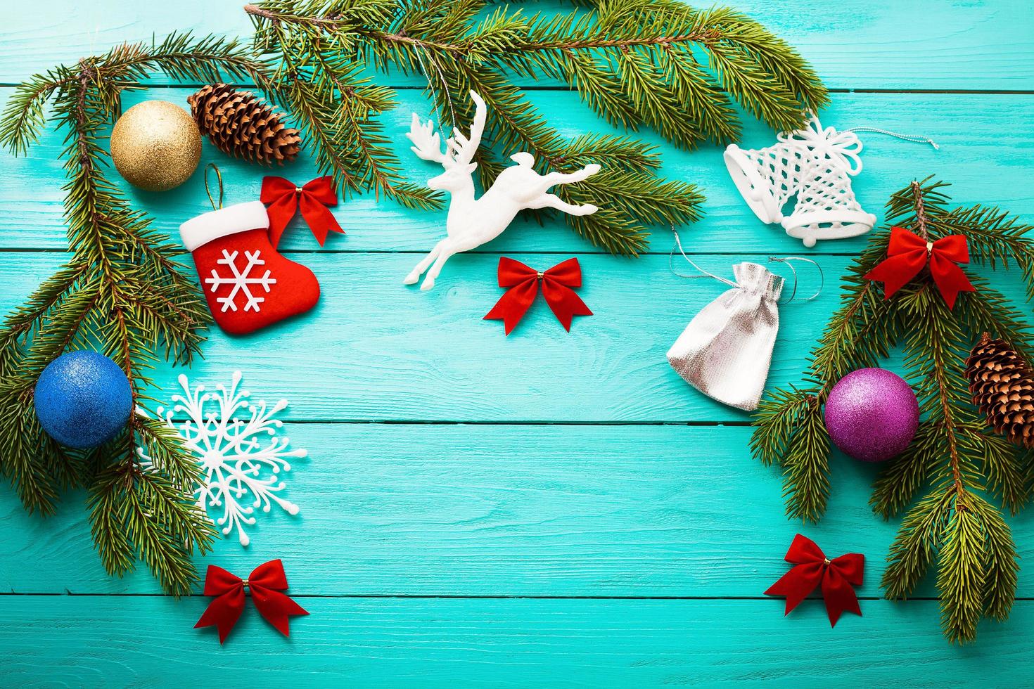 Christmas card with frame of winter accessories on blue wooden background.Top view and selective focus photo