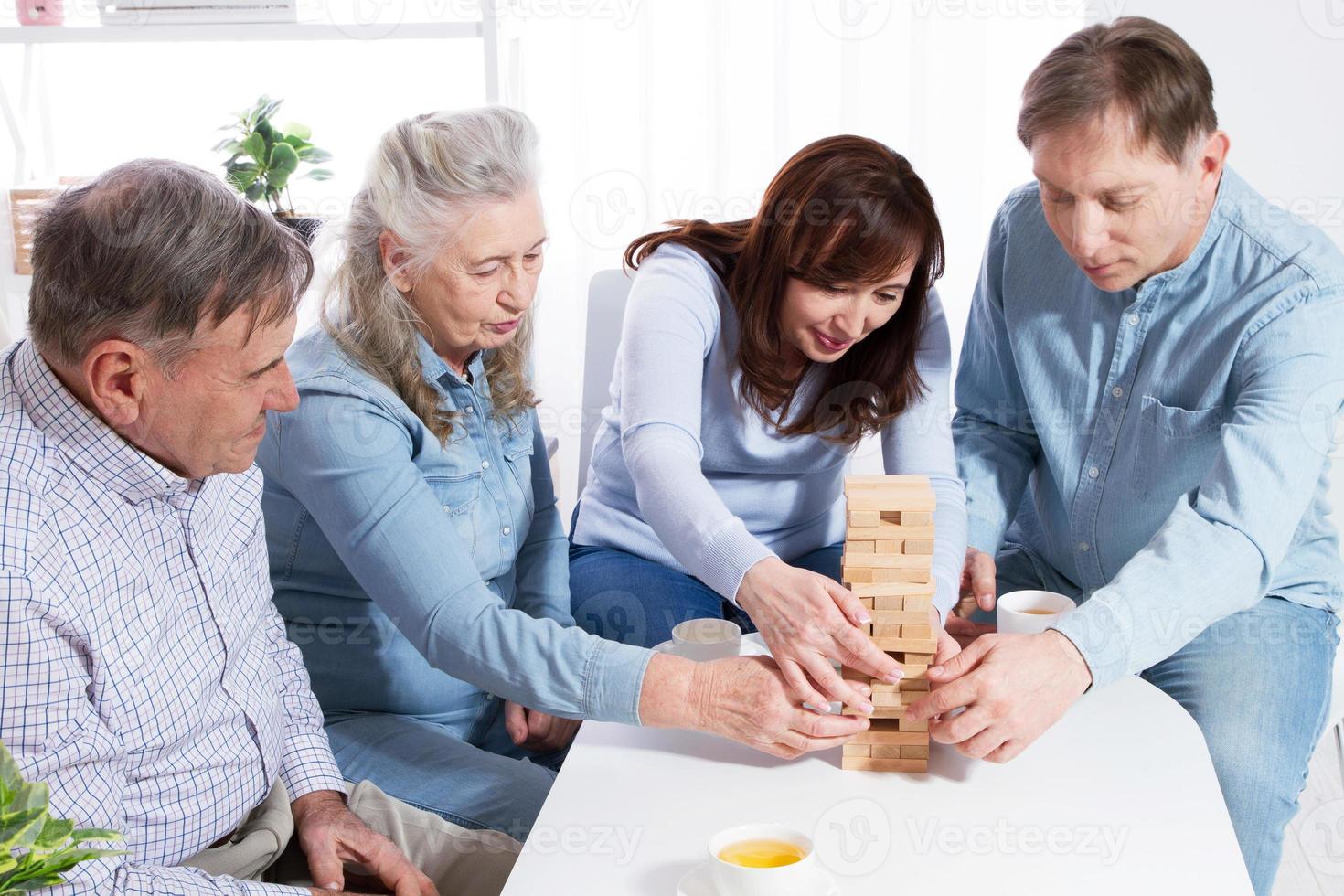 Elderly couple and elderly couple collect wooden blocks at home photo