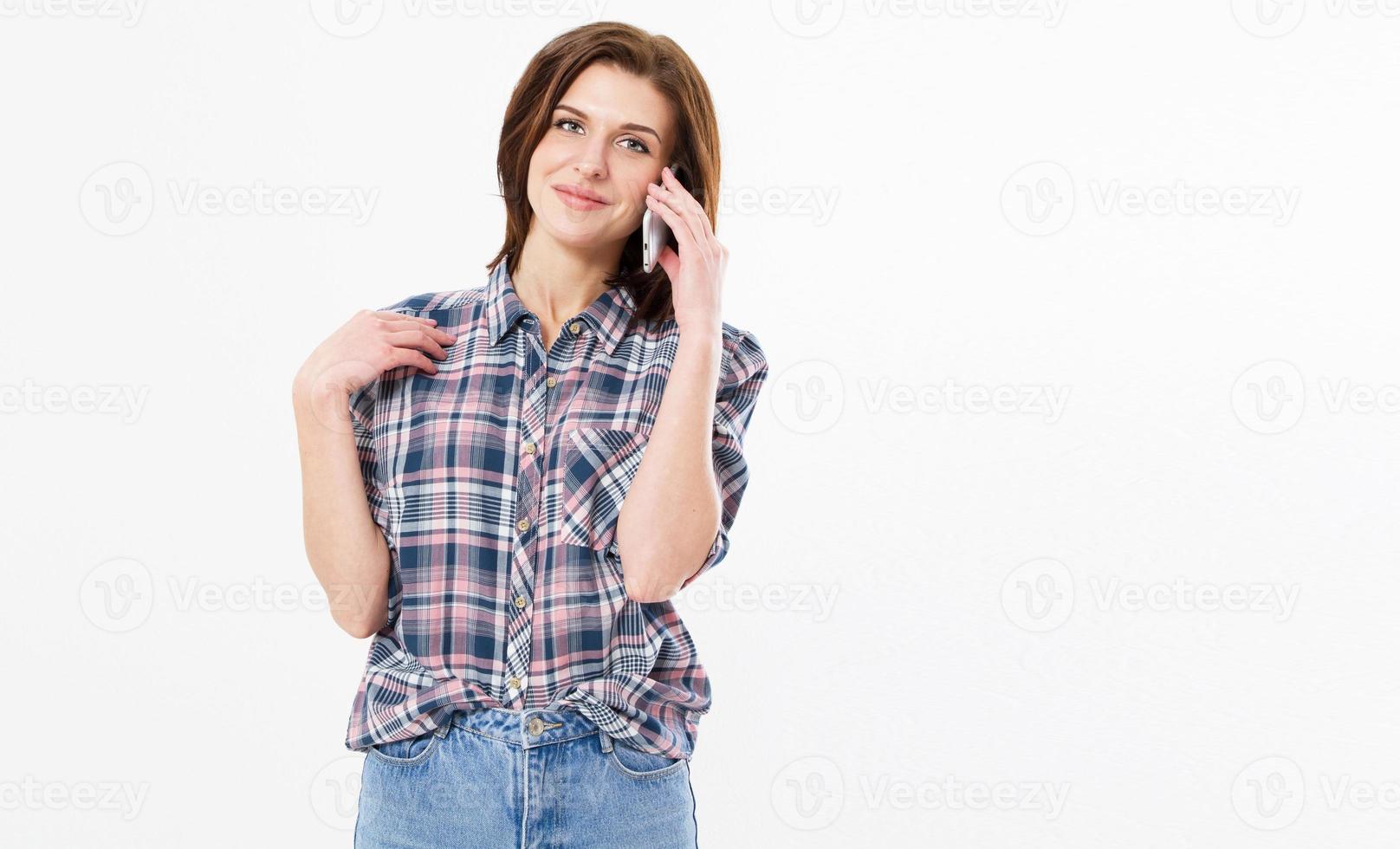 Smiling beautiful teen woman talking on the phone. happy young girl holds cellphone making answering call. Attractive teenager having pleasant conversation chatting by mobile with friend. photo