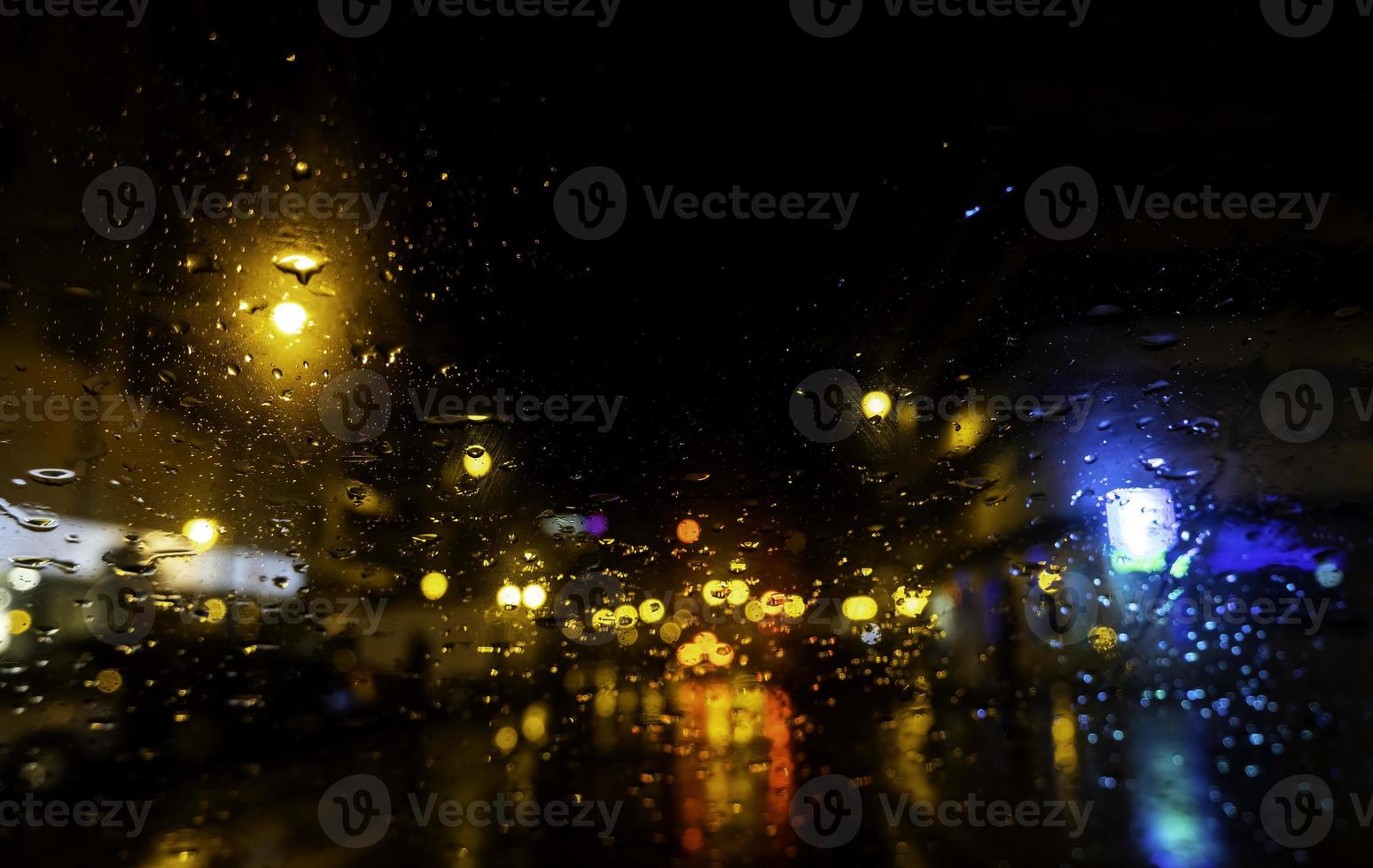 Wet glass with night lights photo