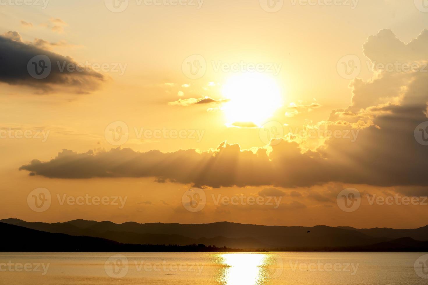 Bright beautiful sunrise or sunset at the river. Dramatic sunset and sunrise sky. Orange and yellow colors sunset. The colorful sunset at the dam in Thailand. Success freedom happy life concept. photo