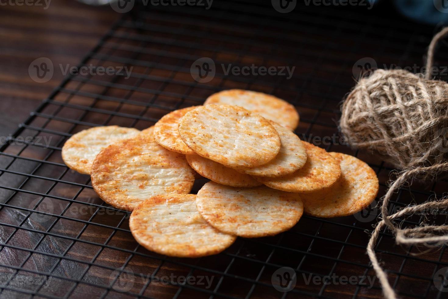 Crispy crackers on a black circle, black top view. photo