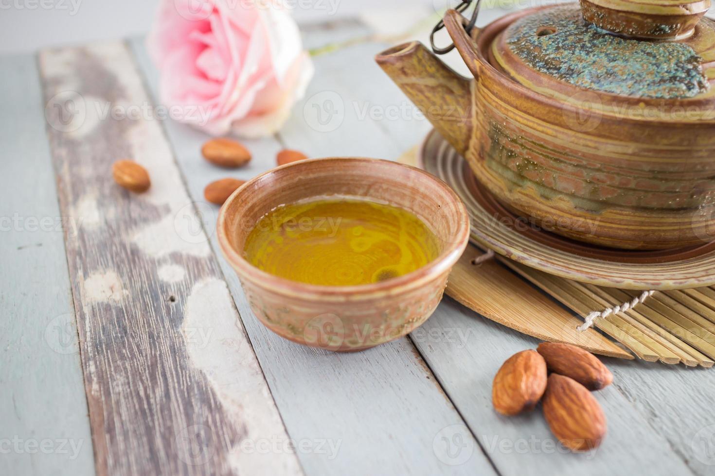 tea set and almon nut on old wood background photo