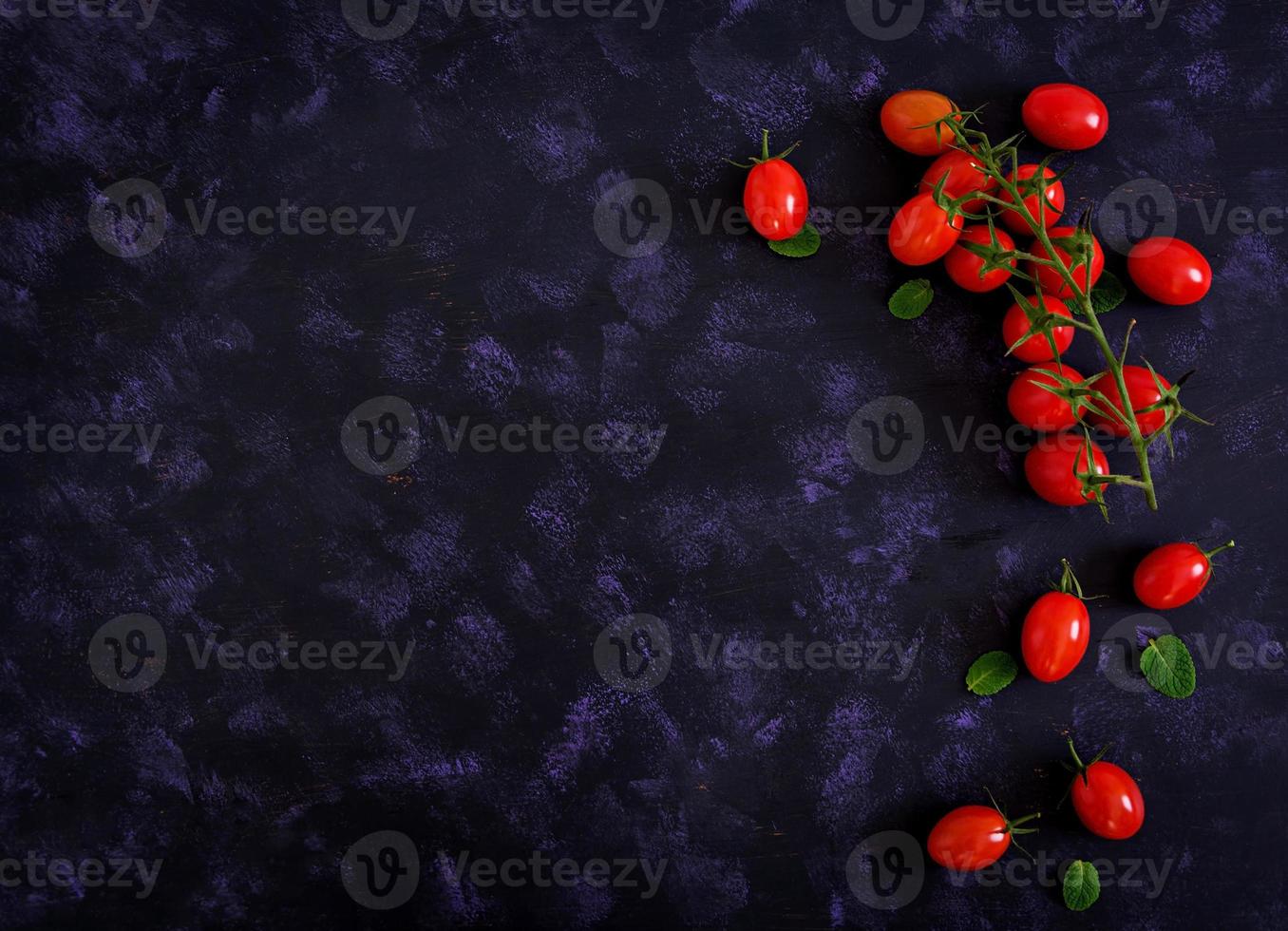 Fresh ripe cherry tomatoes on a dark background. Top view photo