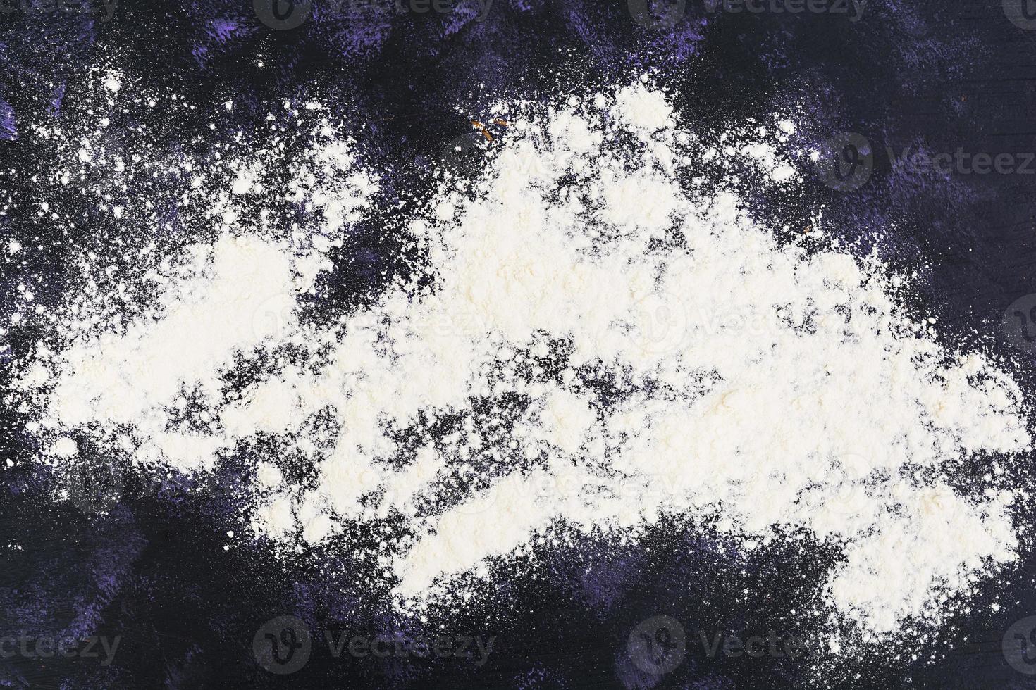 Dough for baking or pastry on dark background. Top view photo