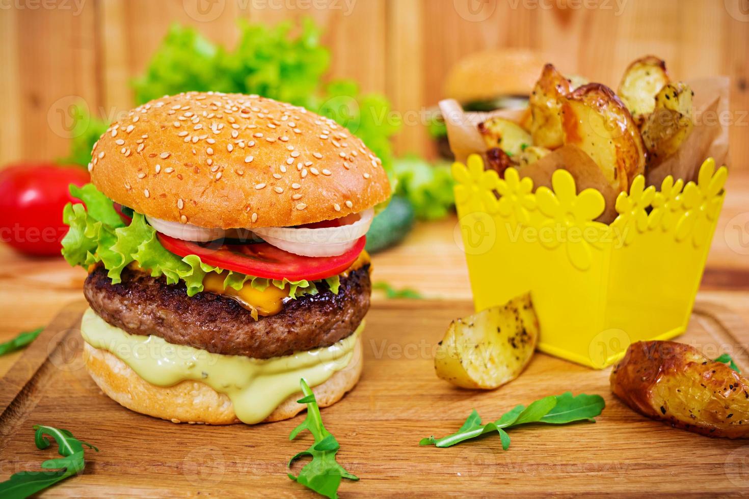 Delicious handmade burger on wooden background. Close view photo