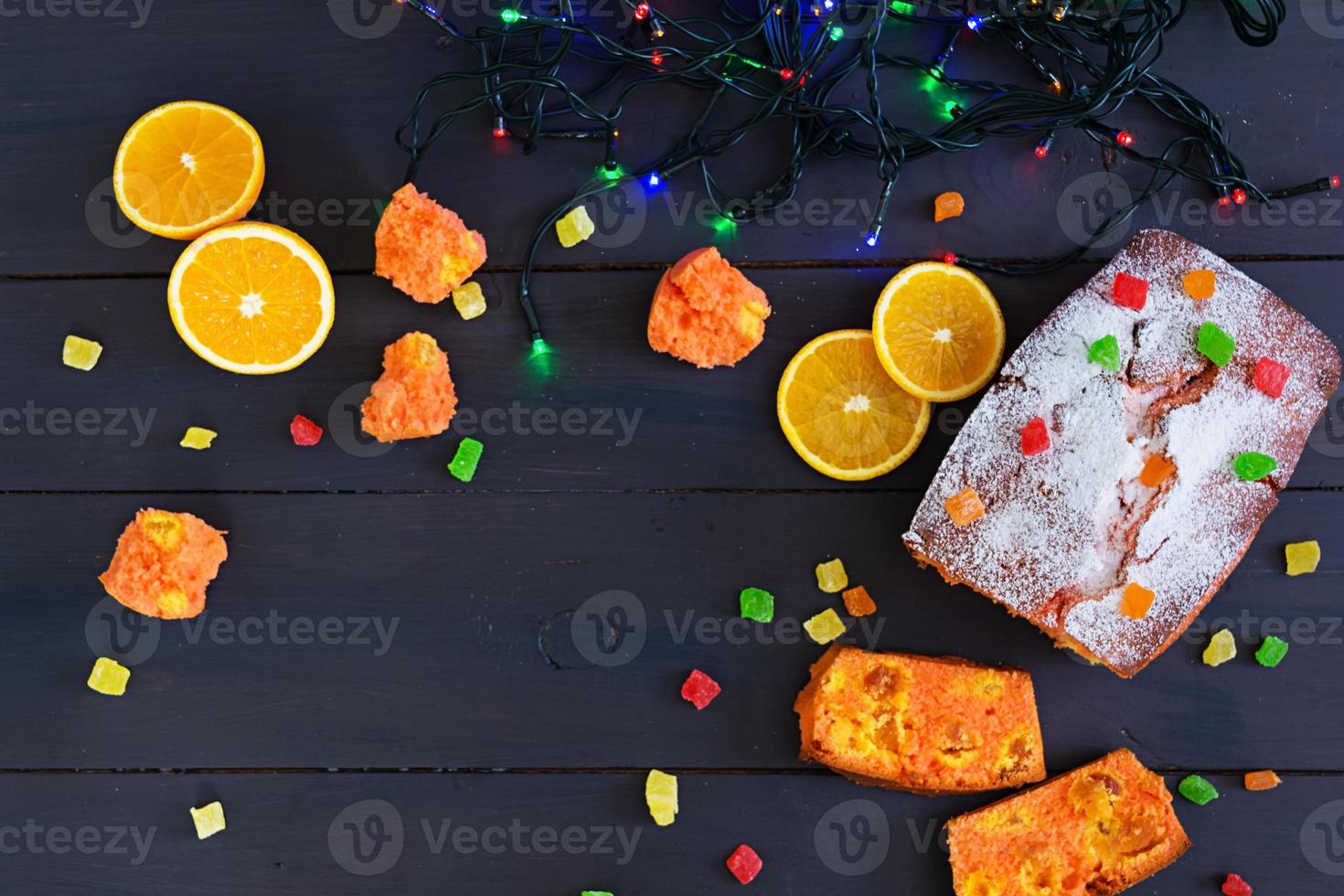 Cupcake with orange and dried apricots on Christmas background photo