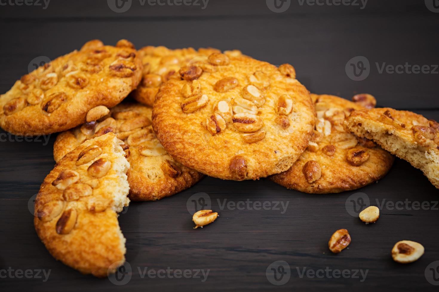 Cookies with peanuts on dark wooden background photo