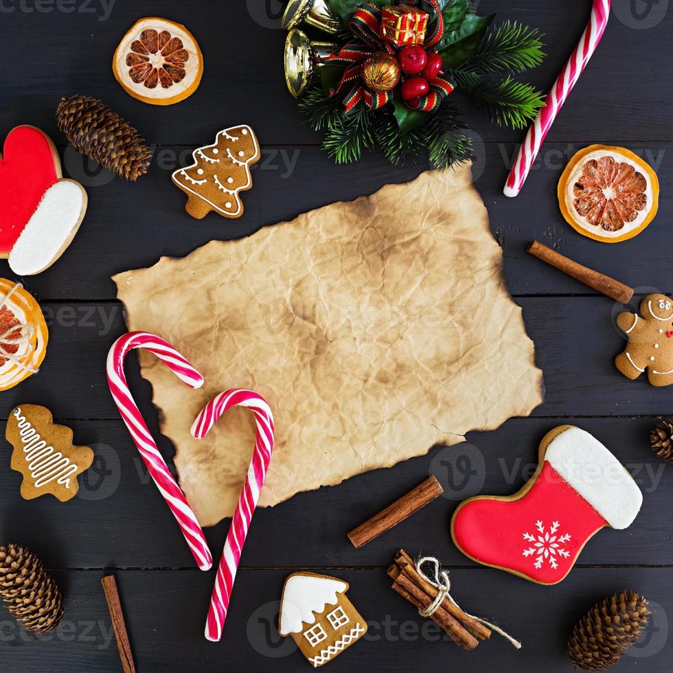 Christmas sweets, ginger cookies on wooden background. Christmas background photo