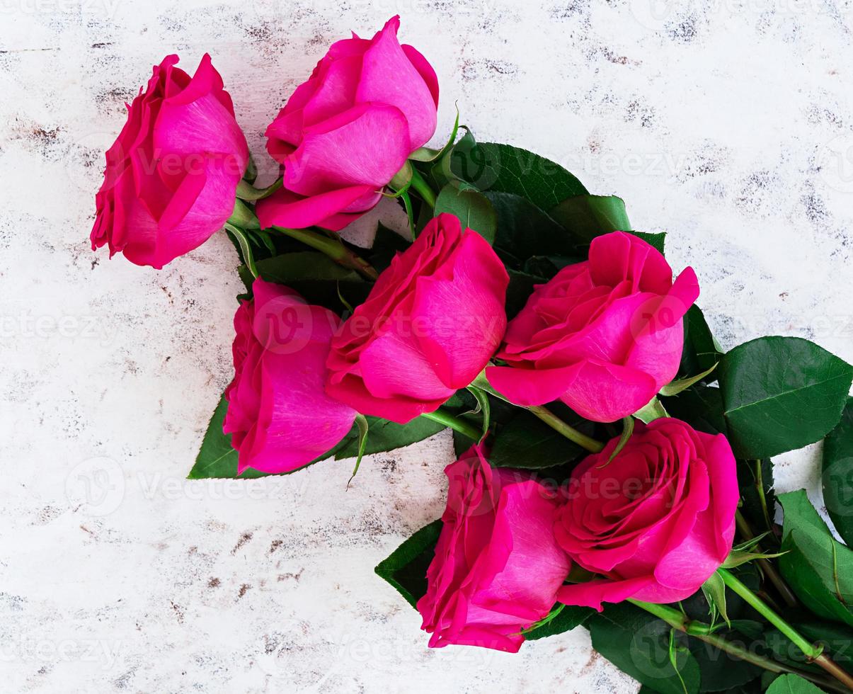 Bouquet of pink roses on dark background. Top view photo