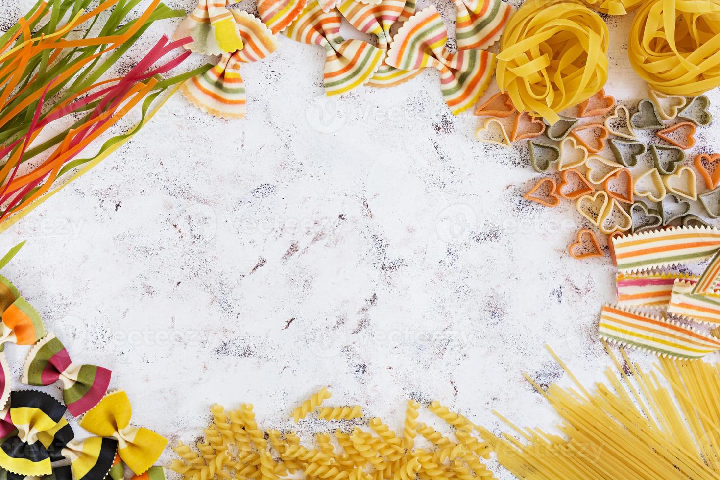 Dry pasta background. Different pasta on white background. Flat lay. Top view. photo