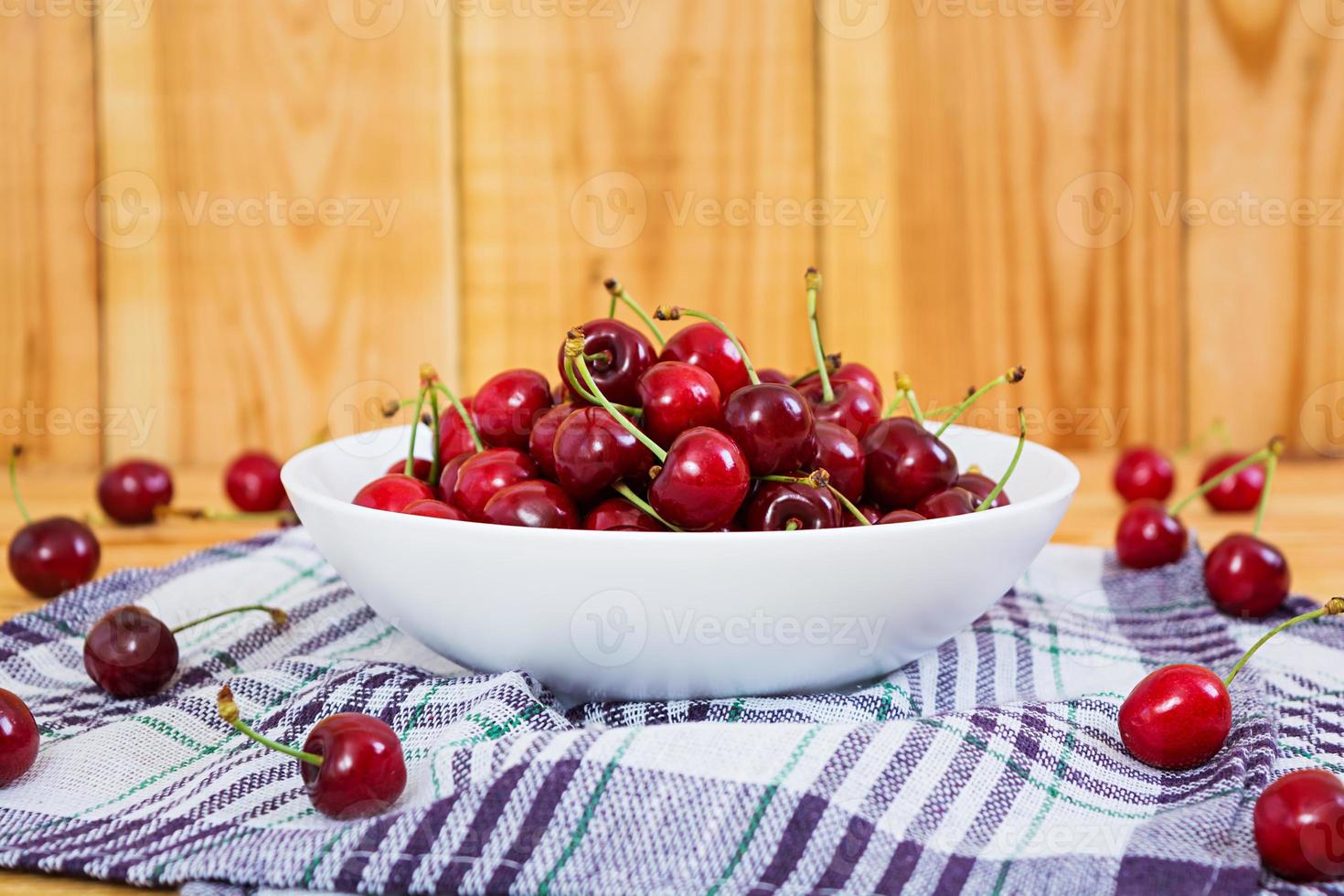 Tasty sweet cherry on wooden background photo