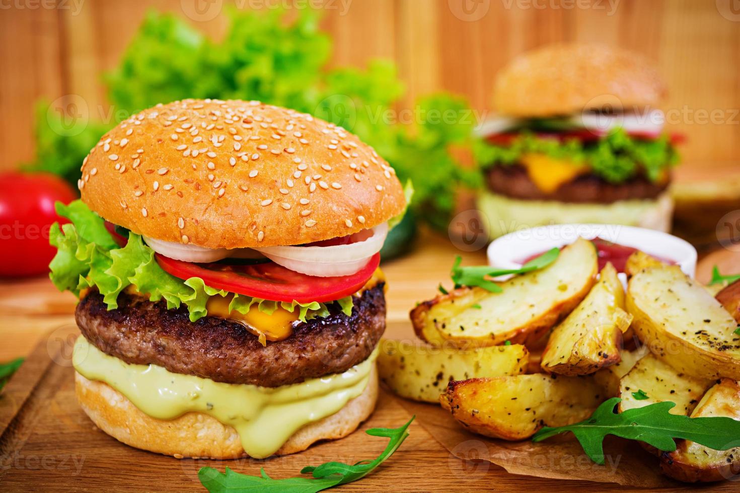 Delicious handmade burger on wooden background. Close view photo