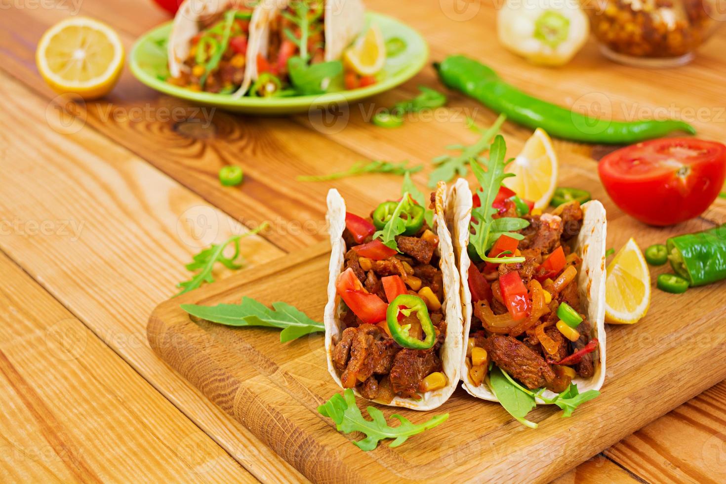 Mexican tacos with beef in tomato sauce photo