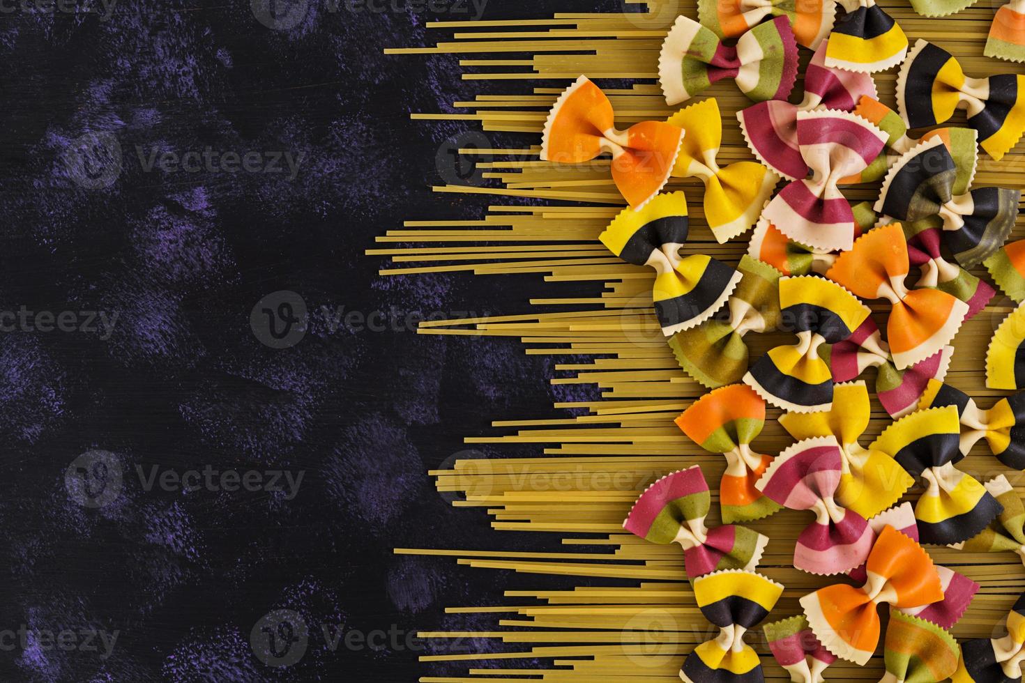 Mixed colorful farfalle pasta. Flat lay. Top view. photo