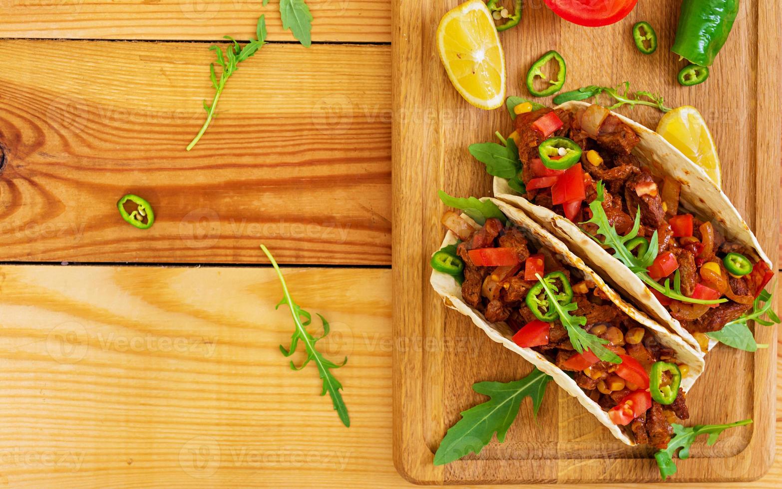 Mexican tacos with beef in tomato sauce photo