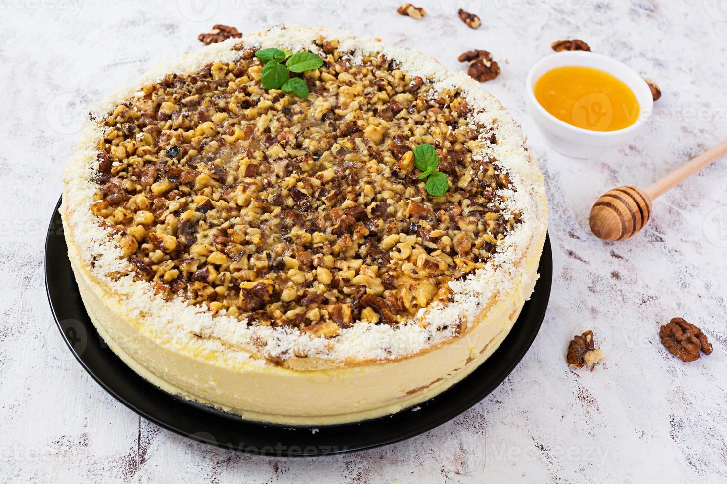 Honey cake with cottage cheese, oranges and nuts, decorated with white chocolate photo