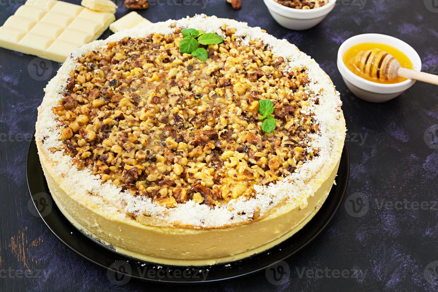 Honey cake with cottage cheese, oranges and nuts, decorated with white chocolate photo