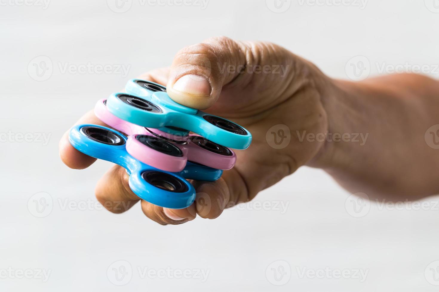 Three hand spinners in the fingers. photo
