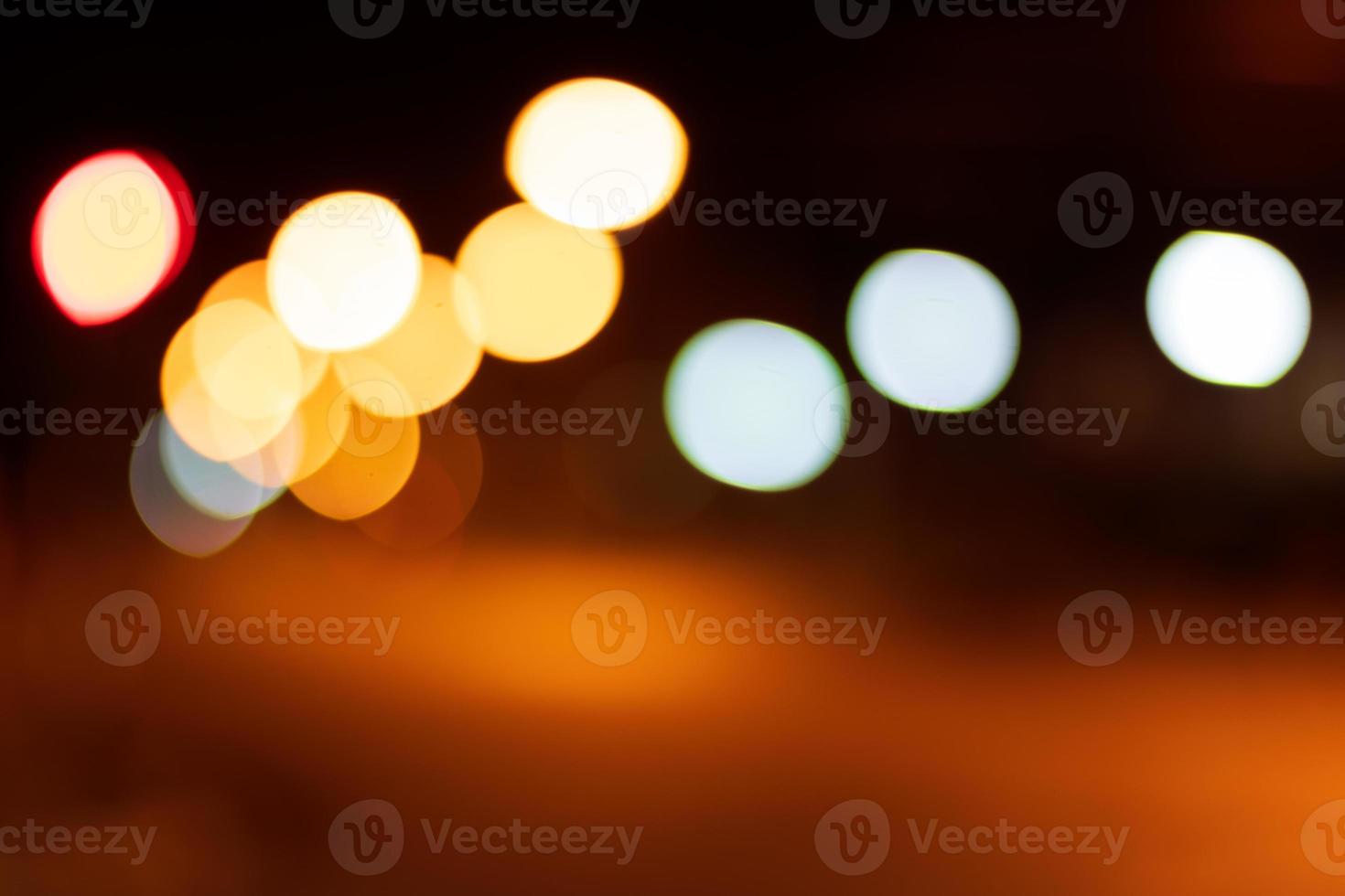 Bokeh blur, car headlights on orange light road. photo